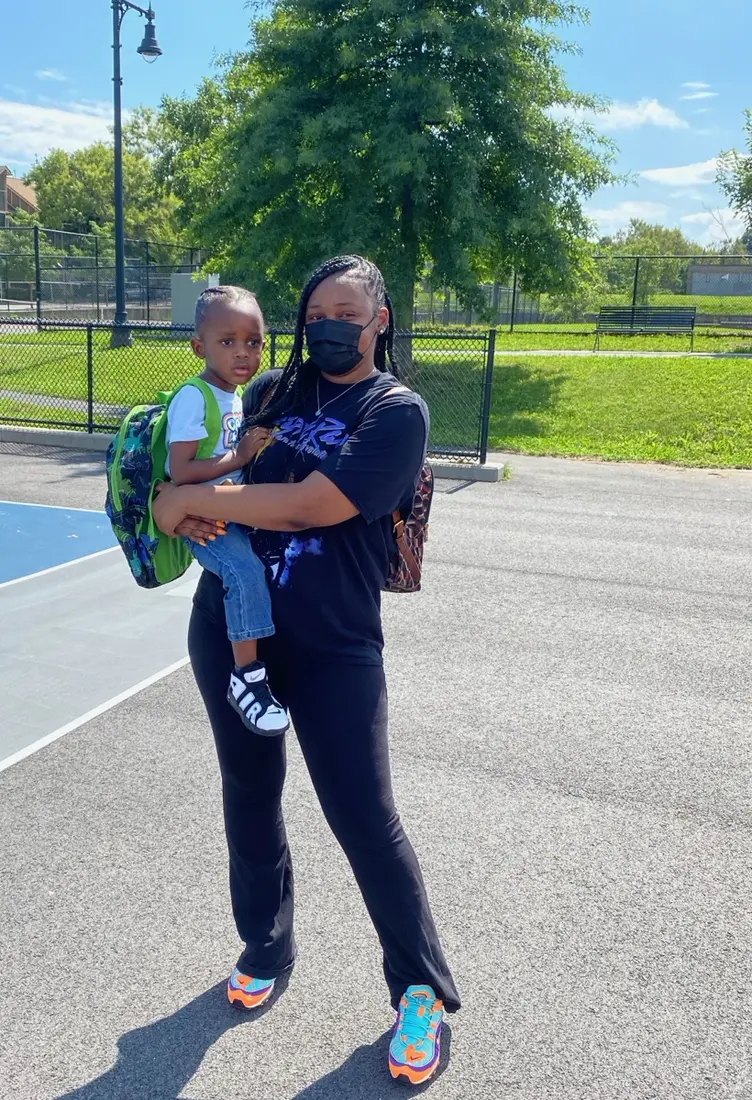 A parent and child attending a JTSA community backpack giveaway