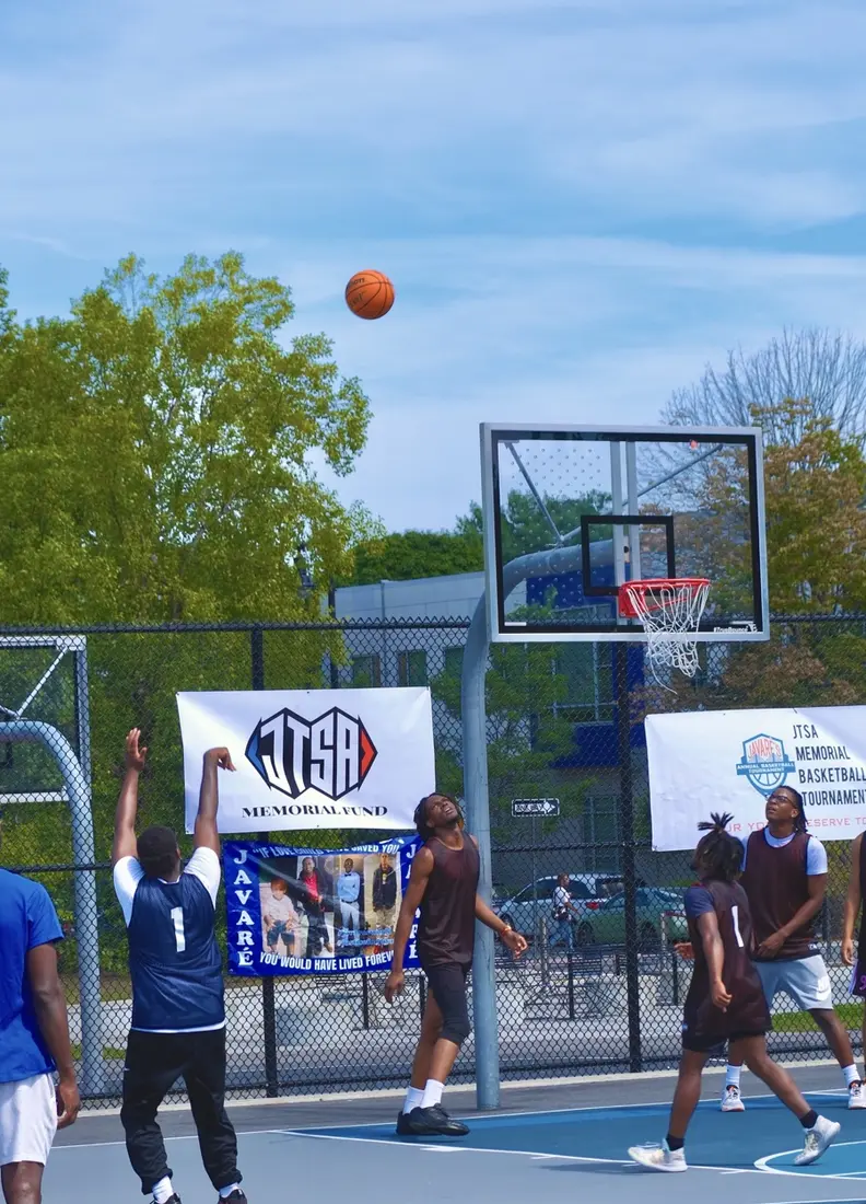 Young people playing basketball at a JTSA Memorial Fund community tournament