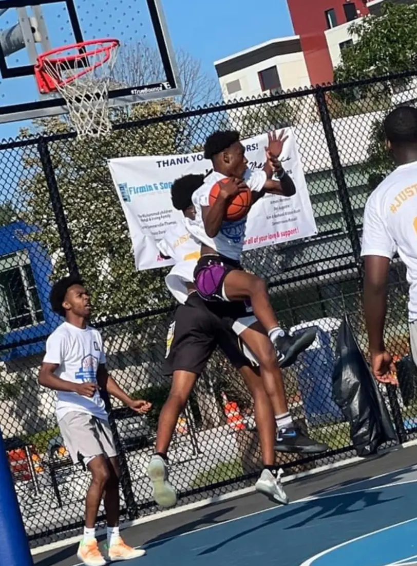 Young athlete driving toward the basket during a JTSA tournament